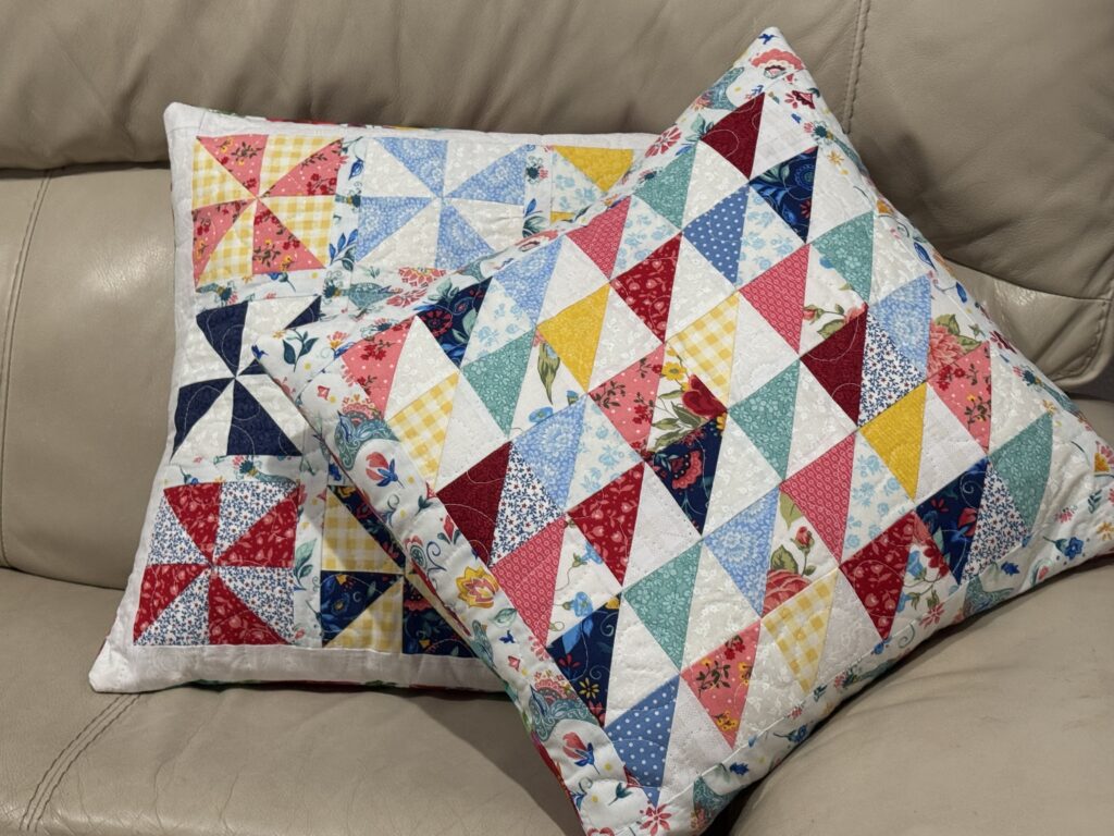 colorful quilted pillow covers using scrap half square triangles and pinwheels